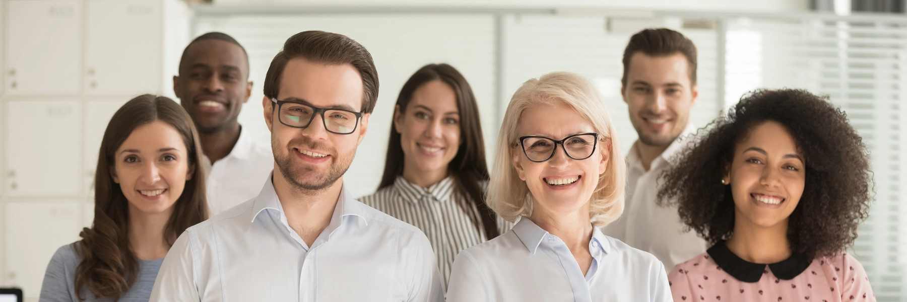 Group of diverse faculty members posing and smiling